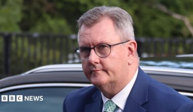 Jeffrey Donaldson - in a navy suit and a green tie