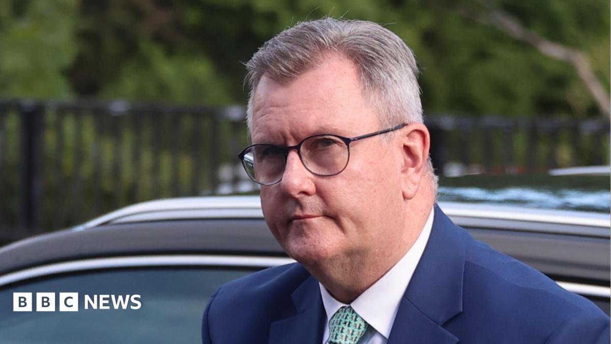 Jeffrey Donaldson - in a navy suit and a green tie