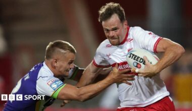 Joe Burgess carries the ball wearing a white and red Hull KR kit