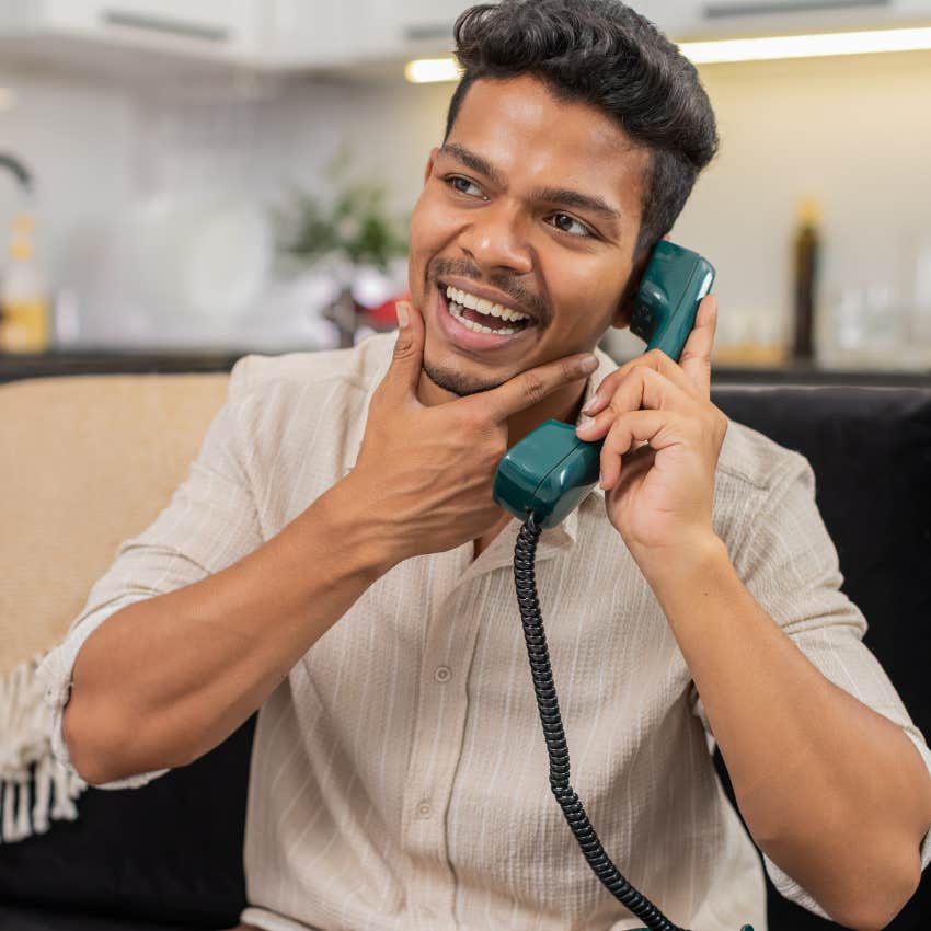 man using a landline who still has retained the skill of memorizing phone numbers