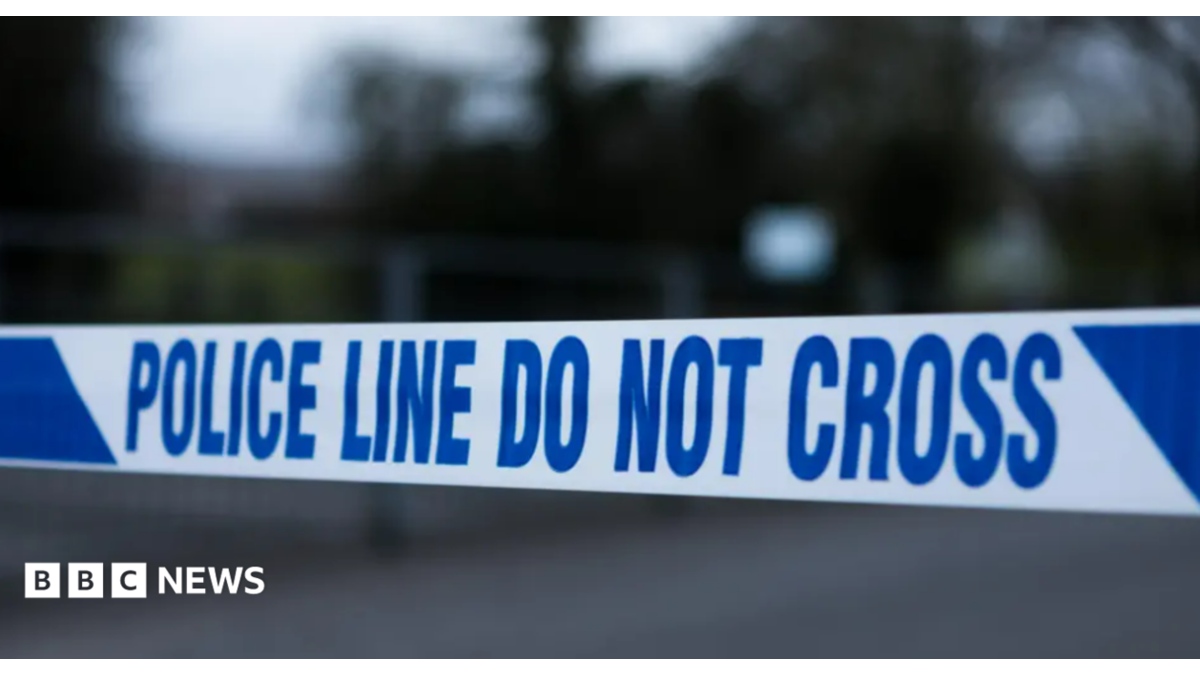 Police tape in white and blue reading "police line do not cross"