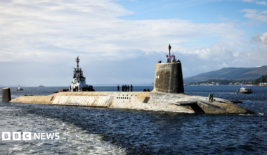 A shot of a Vanguard submarine half submerged in the water.