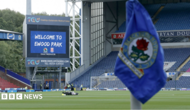 A general view of the inside of Blackburn Rovers' Ewood Park stadium, with a close-up blurred corner flag in the foreground and the pitch further out