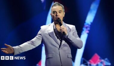 British Singer songwriter Robbie Williams performs on stage during the draw for the 2026 FIFA Football World Cup taking place in the US, Canada and Mexico, at the Kennedy Center, in Washington, DC, on December 5, 2025