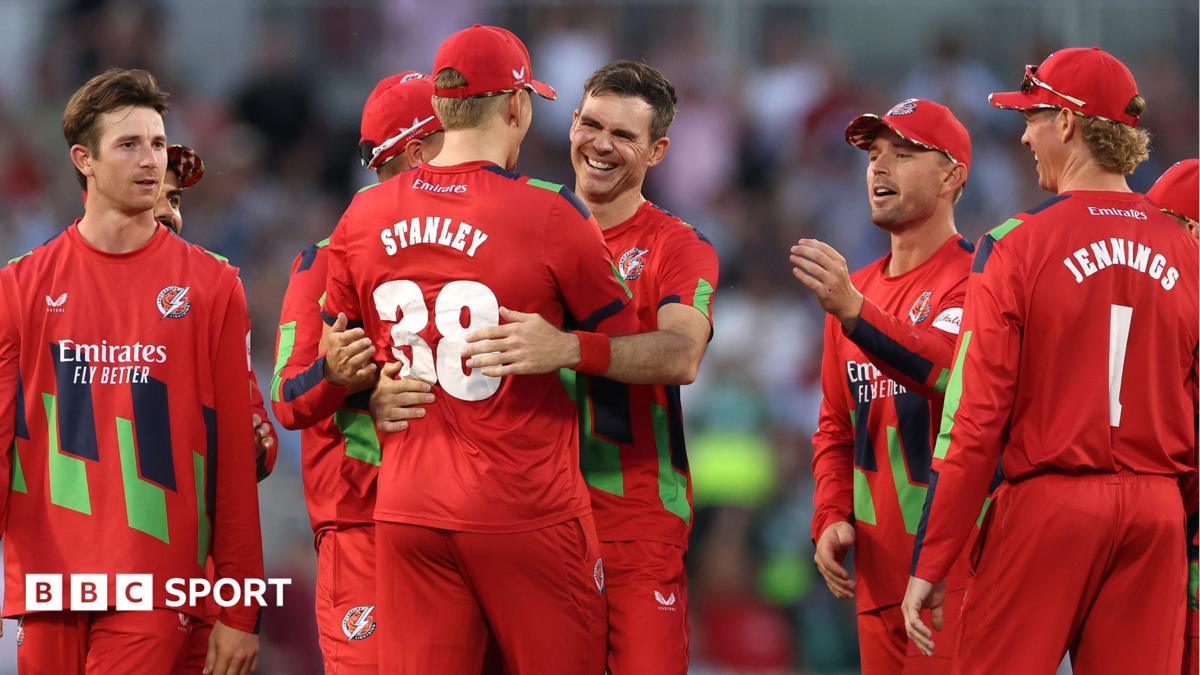 Jimmy Anderson (centre) is hugged by Mitch Stanley (STANLEY 38) with other Lancashire fielders around them after getting the wicket of Joe Root