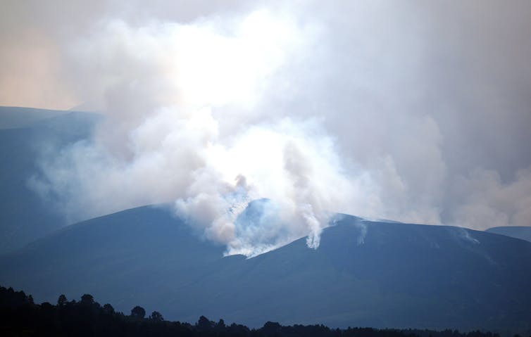 smoke from fire in dark mountains
