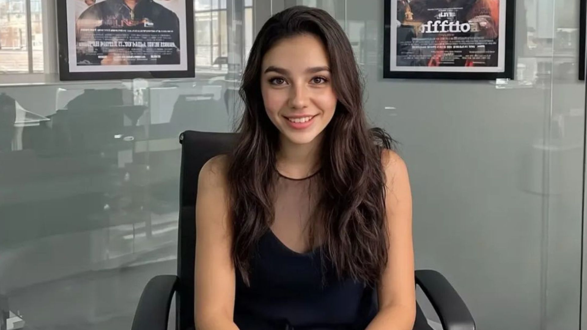 Tilly Norwood, an AI actor, sits in a office looking into camera