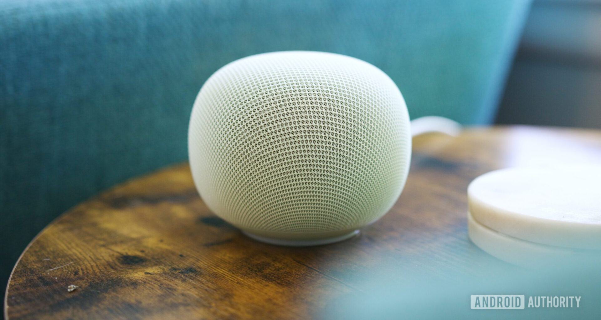 Google Home Speaker sitting on an end table.