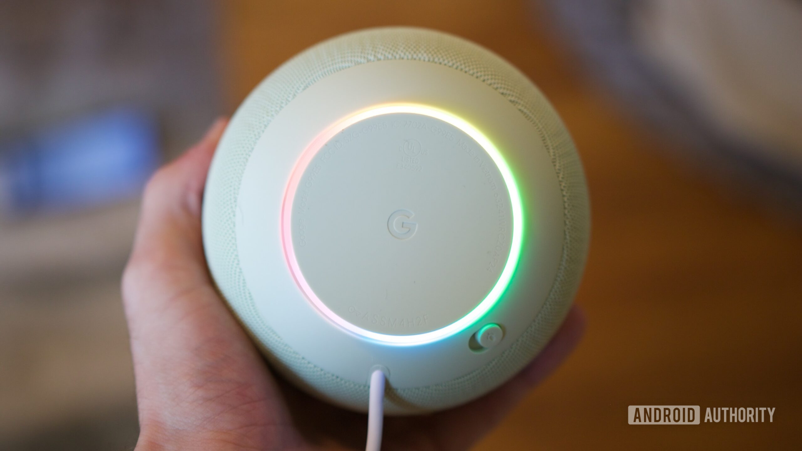 google home speaker review 5 Google Home Speaker with its ring light on.