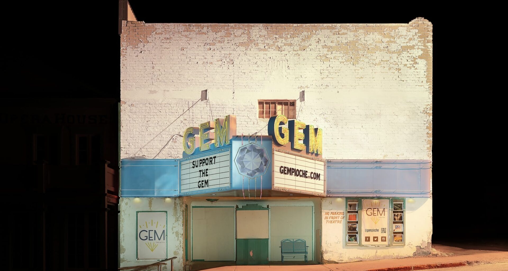 an atmospherically illuminated photograph of a vintage theater called the Gem against an eerily deep black background