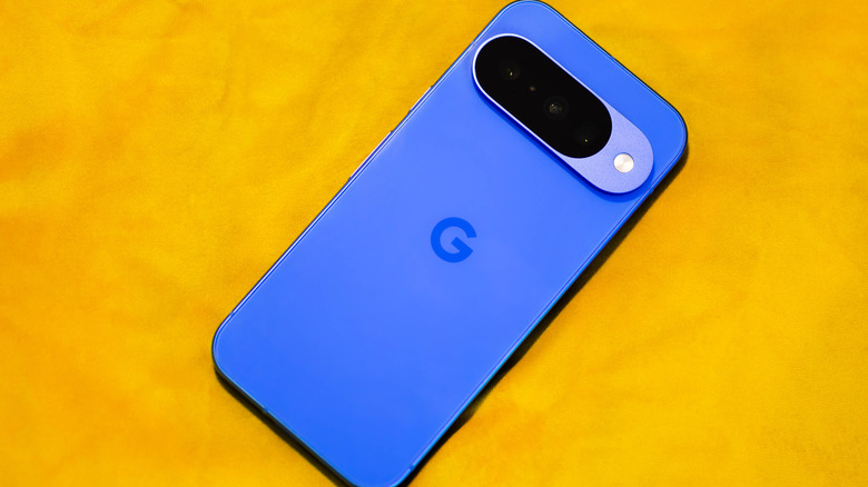 Blue Google Pixel phone placed face down on yellow background