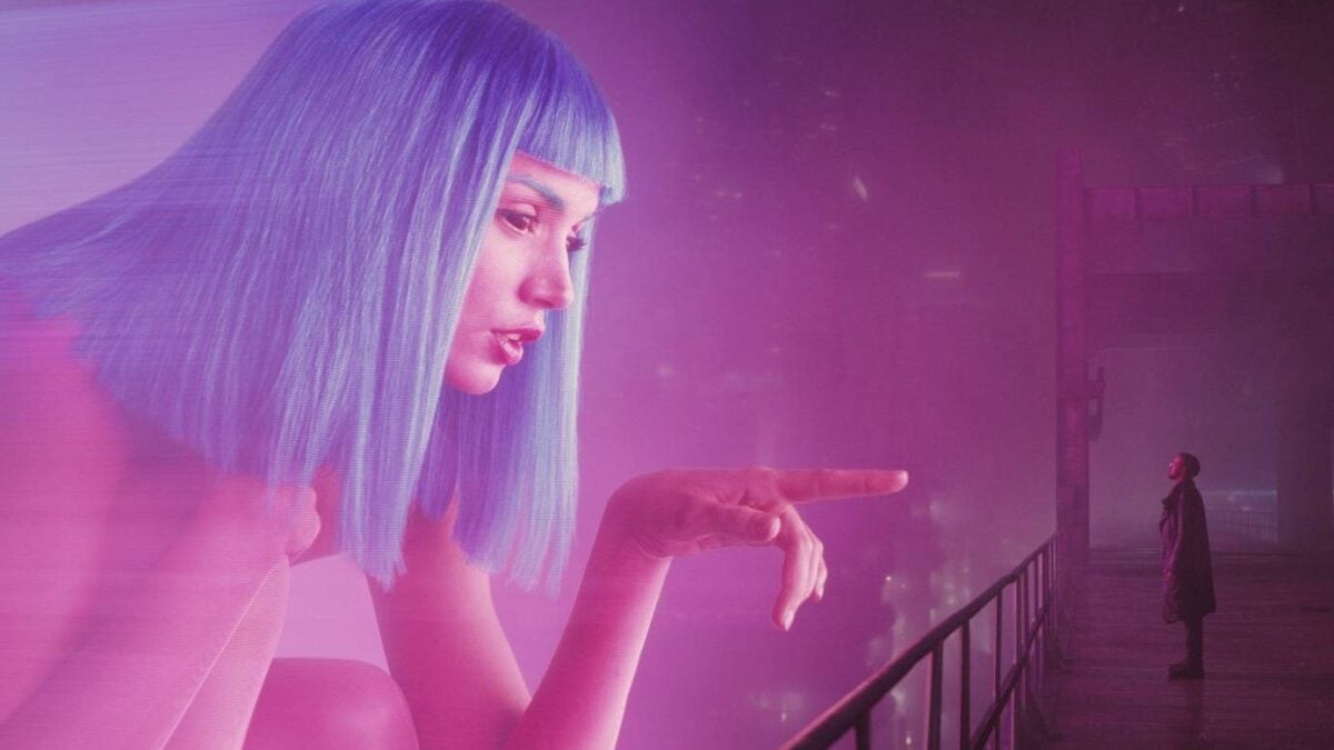 A hologram reaches out to a man.
