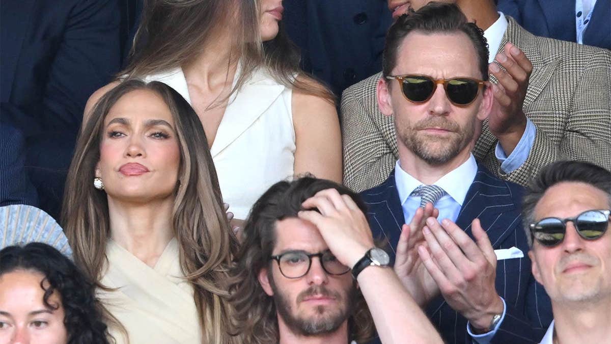 Jennifer Lopez and Tom Hiddleston stand together at Wimbledon in London.