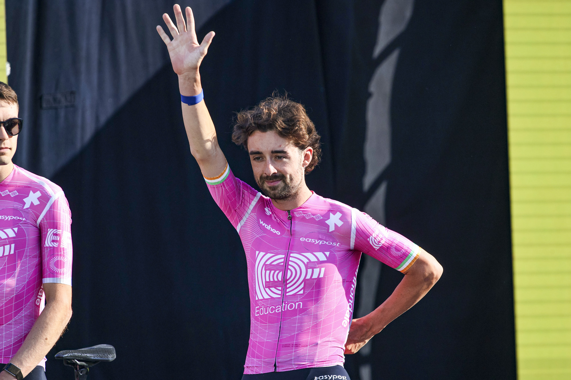 EF Education-EasyPost rider Ben Healy waves at the crowd during the 2026 Tour de France team presentation in front of the Sagrada Familia church in Barcelona