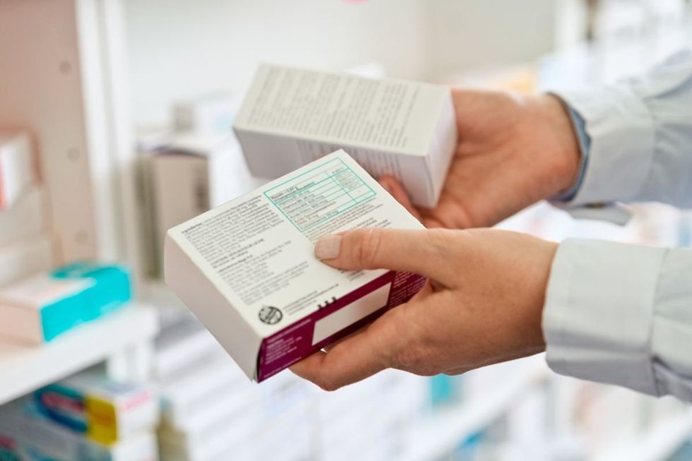 PHARMACIST HOLDING PRESCRIPTION