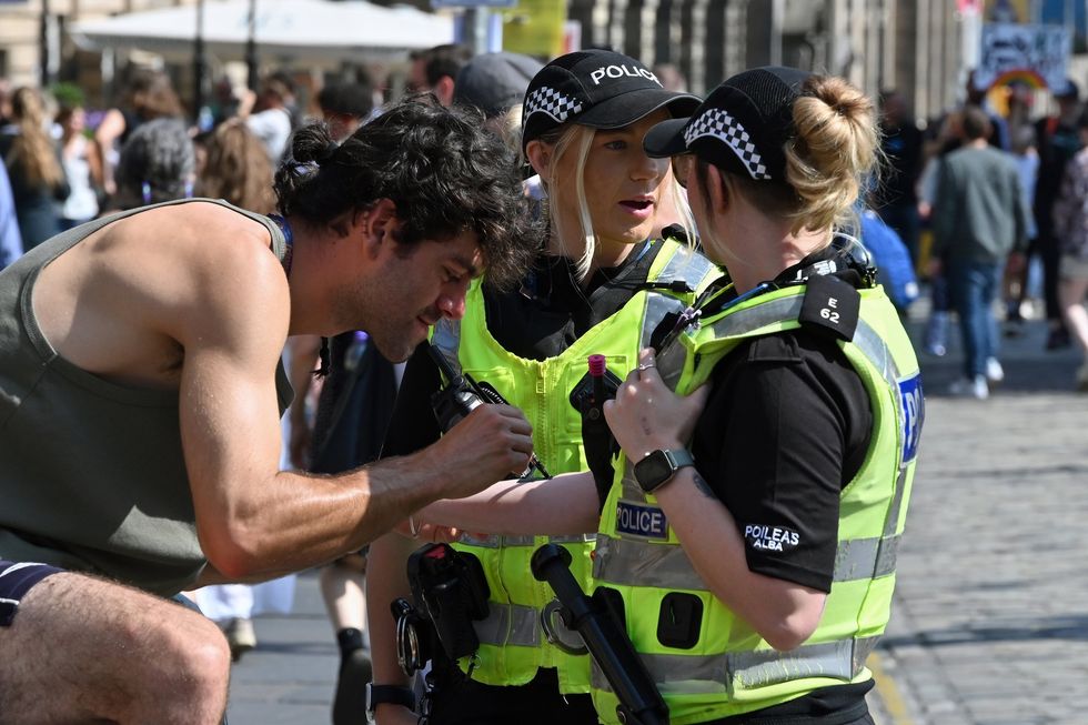 Police officer in Edinburgh gets drawn on during the Festival Fringe