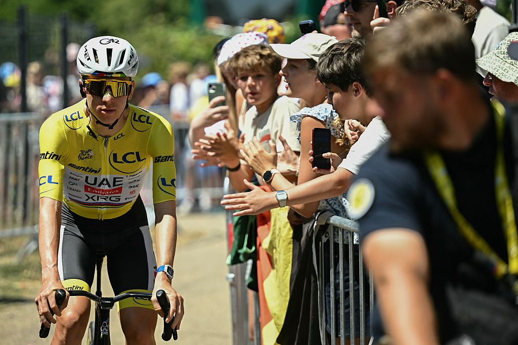 Tadej Pogacar wearing the overall leader's yellow jersey awaits the start of the 19th stage of the 113th edition of the Tour de France
