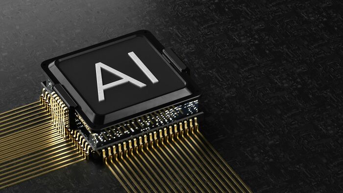 Close-up of an AI processor chip with golden pins, illustrating advanced AI technology on a dark circuit board.