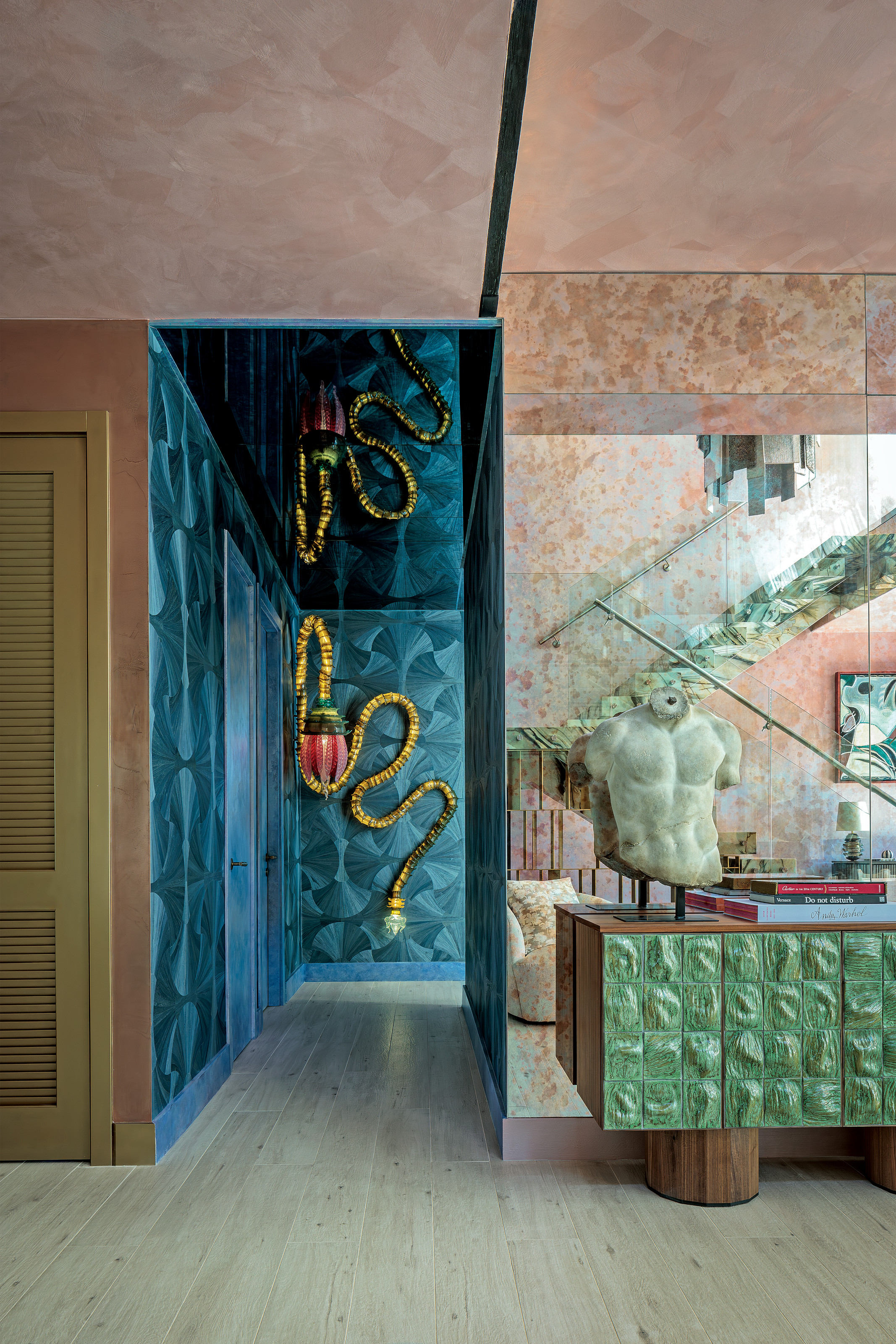 Hallway with teal textured wallpaper and snake lantern, with green textured sideboard at the front