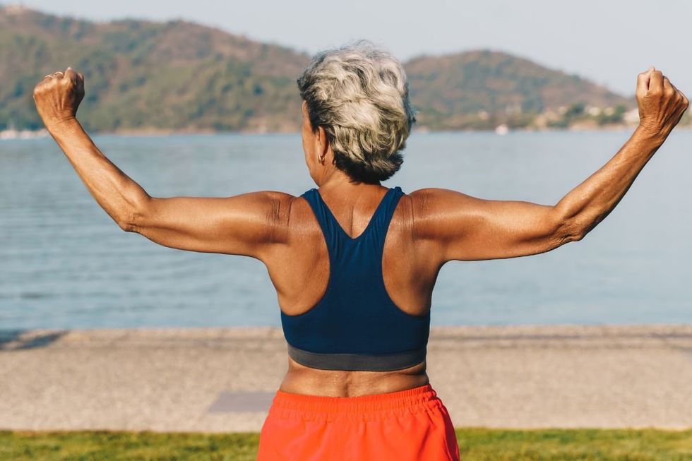 SENIOR WOMAN FLEXING MUSCLES