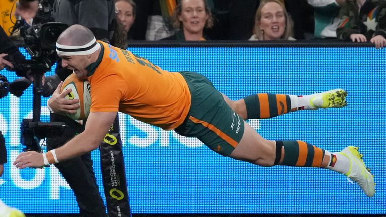 Australia's Dylan Pietsch dives over the line to score his side's first try against Ireland
