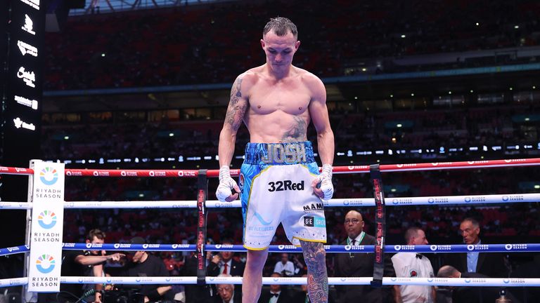 Josh Warrington lays his gloves in the right after losing to Anthony Cacace