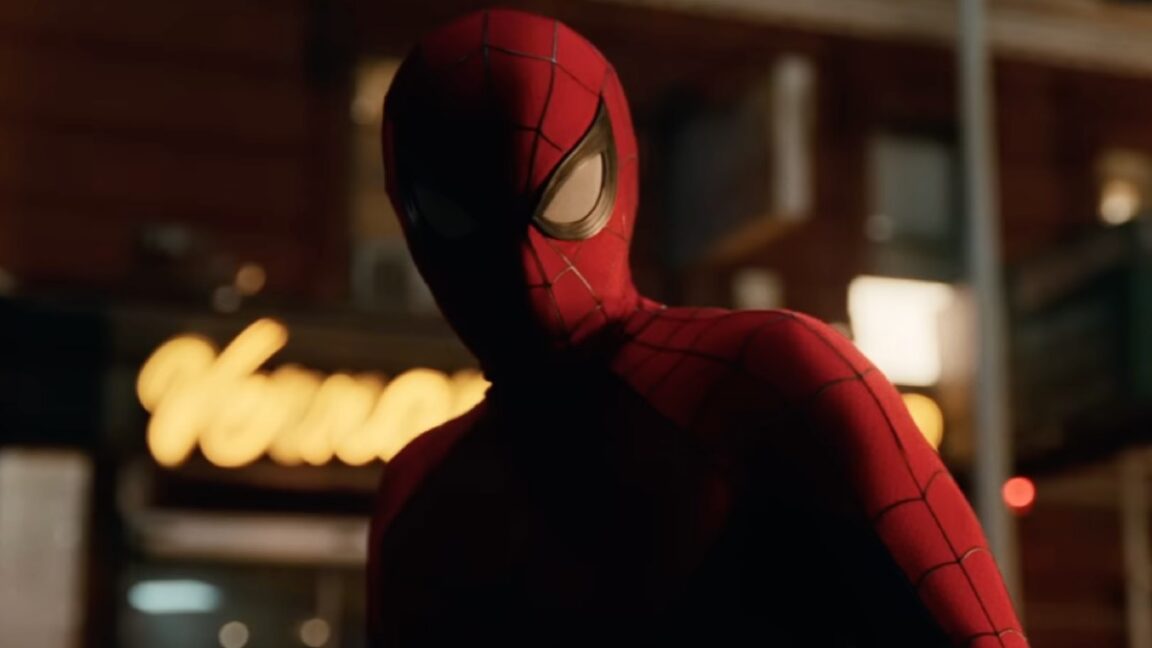 closeup of spiderman on a city street at night