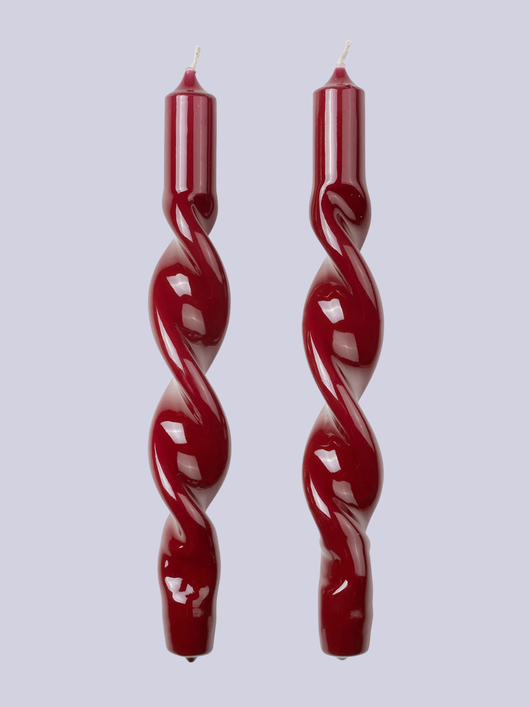 A pair of twisted red candles from Broste Copenhagen