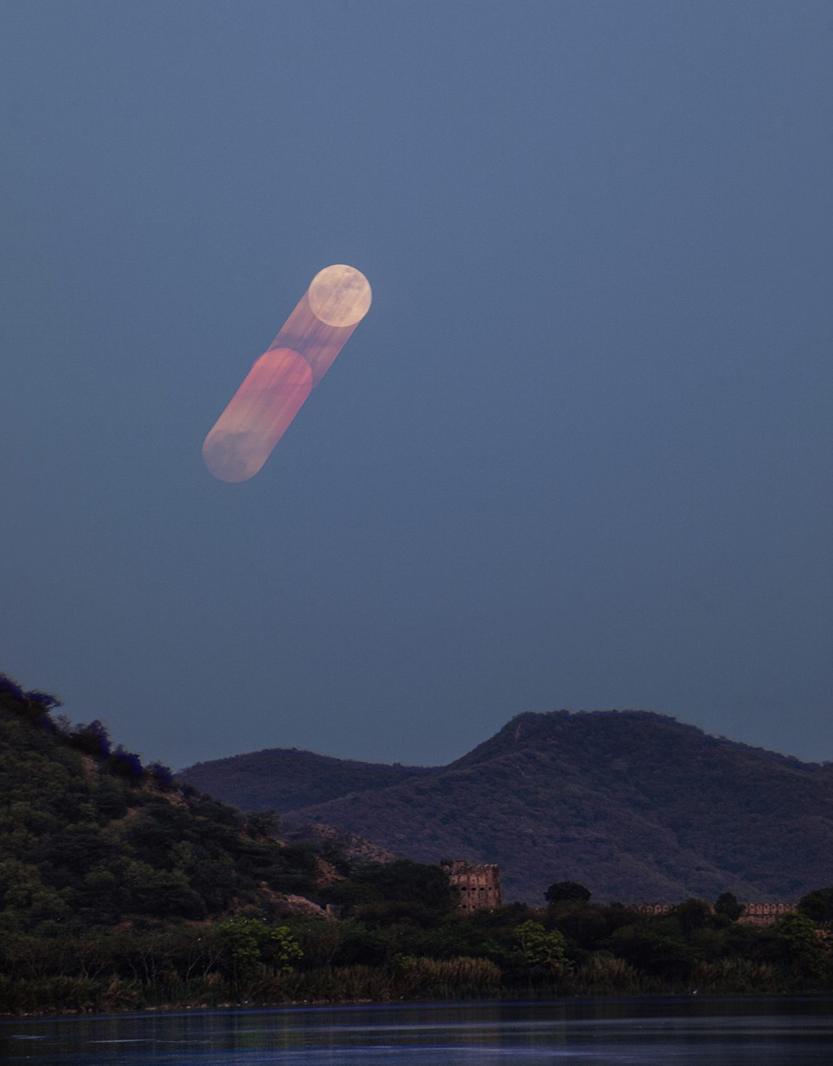 Strawberry Moon rising above Jal Mahal captured by Aquib Ali Ansari, 29 June 2026. Equipment: Canon EOS 5D Mark IV DSLR camera, Sigma 150–600mm contemporary lens, tripod. Exposure: ISO 400, f/8, 1/8s, 211mm. Software: StarStaX (to create the Lunar Drift from over 190 sequential images); Adobe Lightroom (final processing, colour correction, exposure adjustments and finishing)