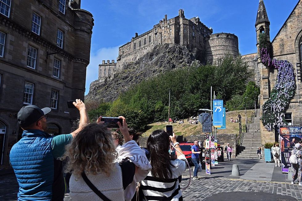Tourists taking pictures of the Edinburgh Castle during the Edinburgh Festival Fringe