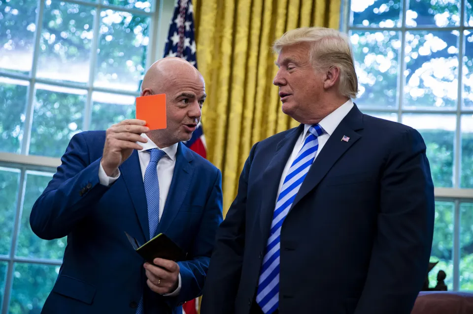 U.S. President Donald Trump, right, is presented a referee red card by Gianni Infantino, president of FIFA, in the Oval Office of the White House in Washington, D.C., U.S., on Tuesday, Aug. 28, 2018