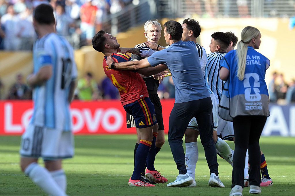 Leandro Paredes throttles Spain's defender #04 Eric Garcia at the end of the 2026 World Cup football tournament final match between Spain and Argentina. (Photo by JUAN MABROMATA / AFP)