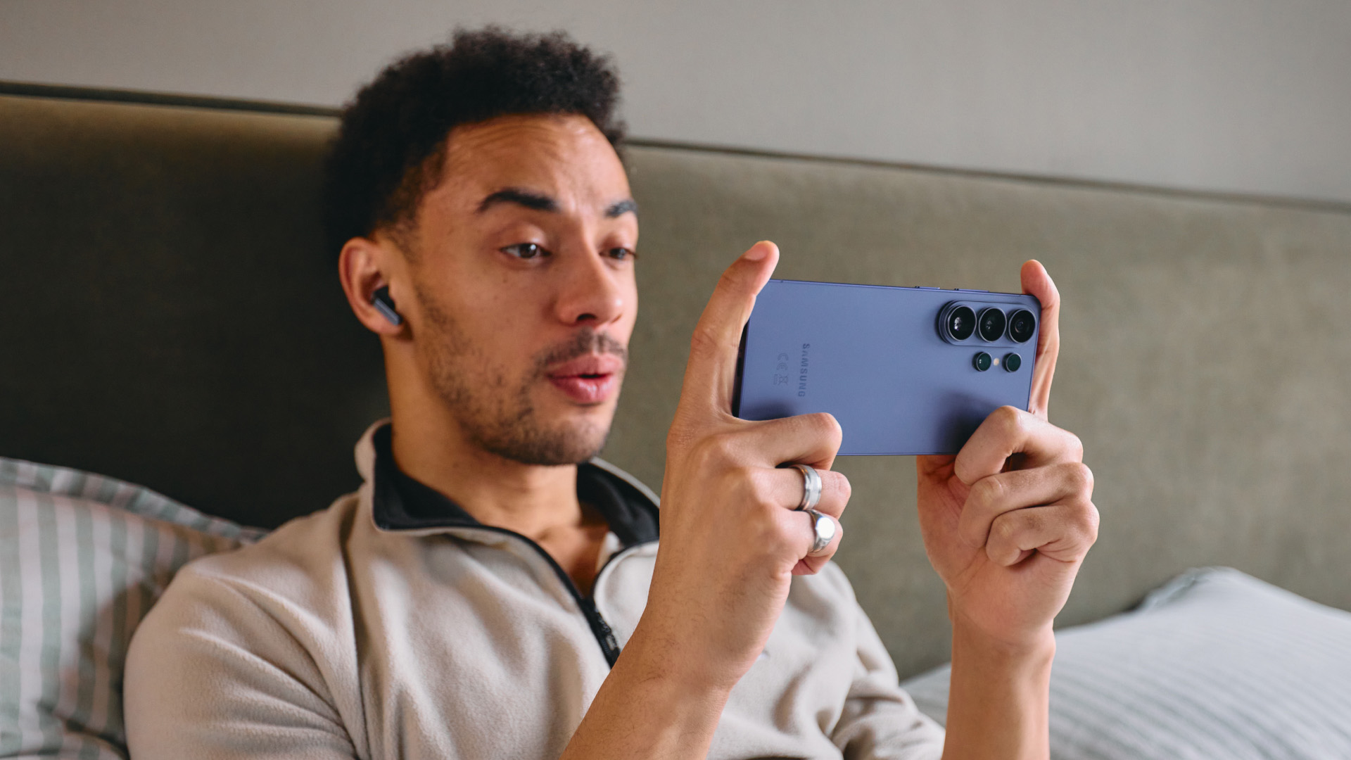 A man playing a game on a Samsung Galaxy S26 Ultra.