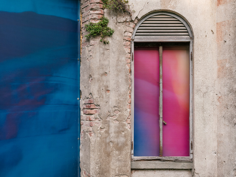 colorful printed textile installation reimagines historic laundry building facade in switzerland - 7