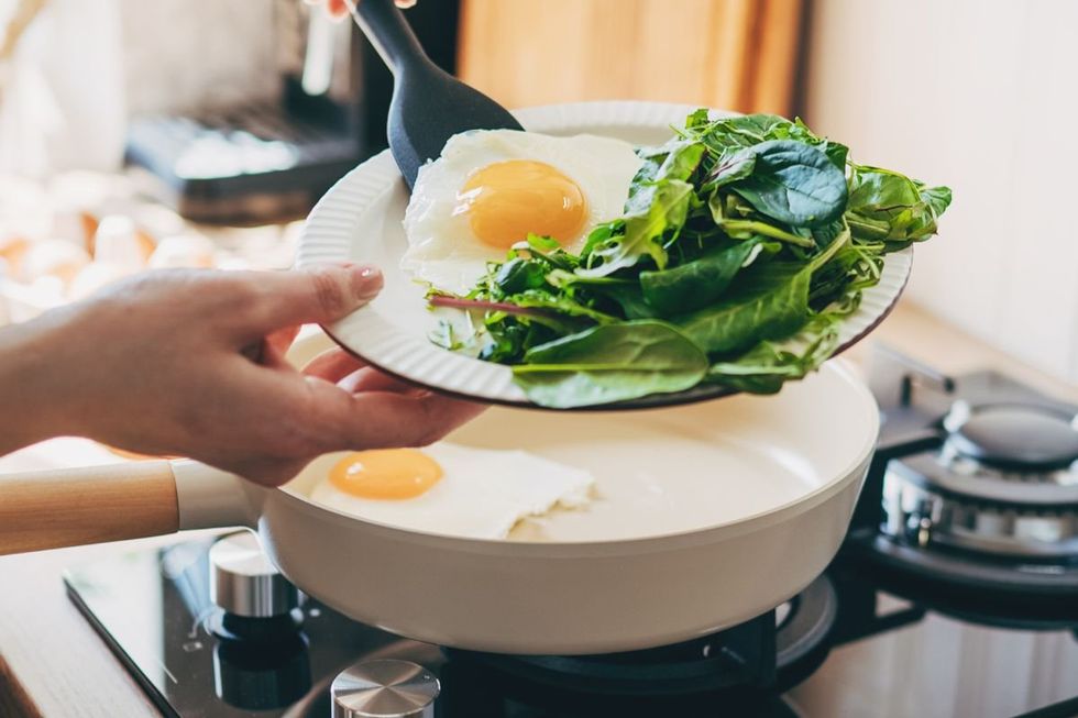 WOMAN SERVING EGGS