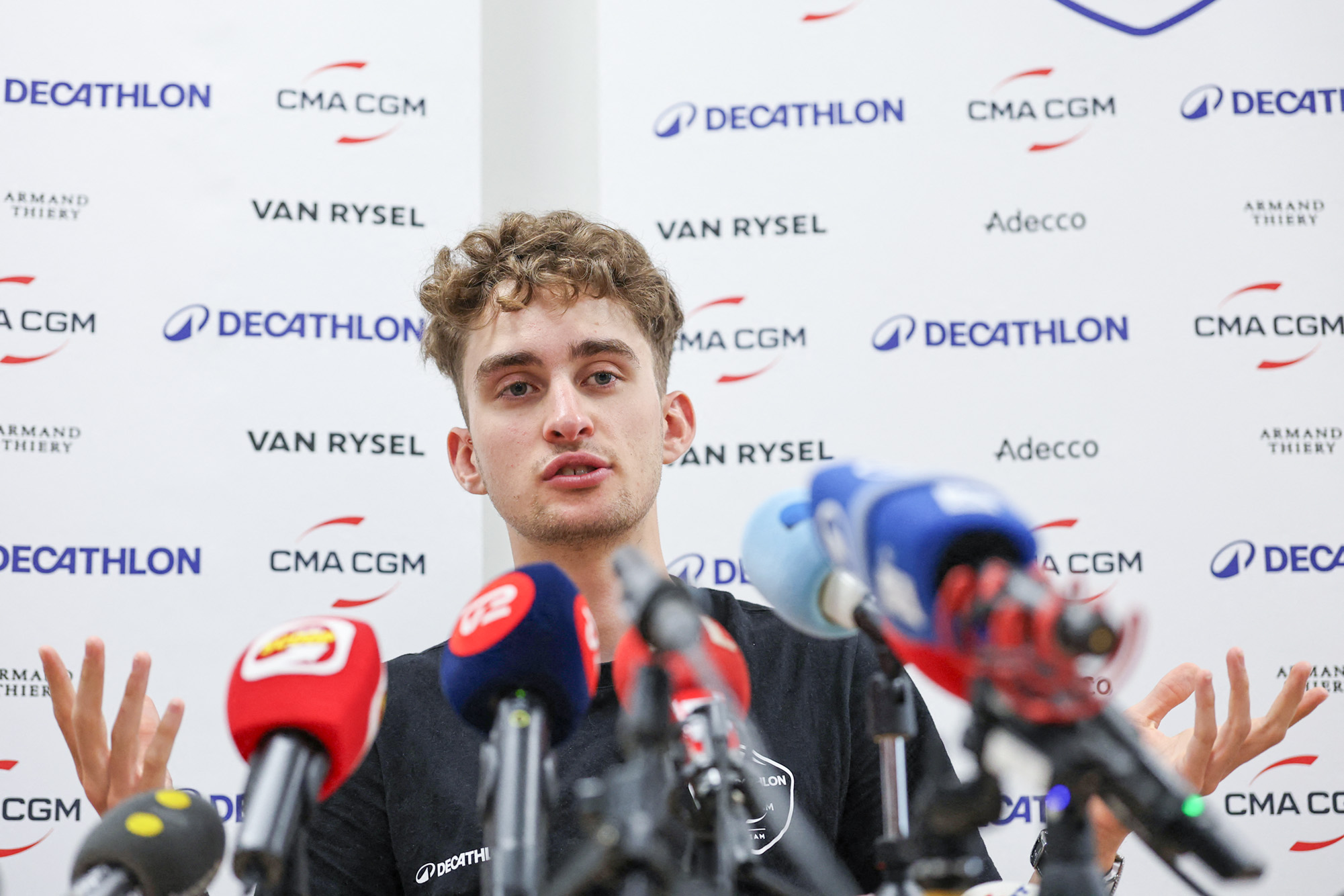 Decathlon CMA CGM Team's French rider Paul Seixas speaks during a press conference on the eve of the start of the Tour Auvergne-Rhone-Alpes cycling race (formerly known as the Criterium du Dauphine) in Voiron, French Alps, on June 6, 2026. (Photo by Anne-Christine POUJOULAT / AFP via Getty Images)