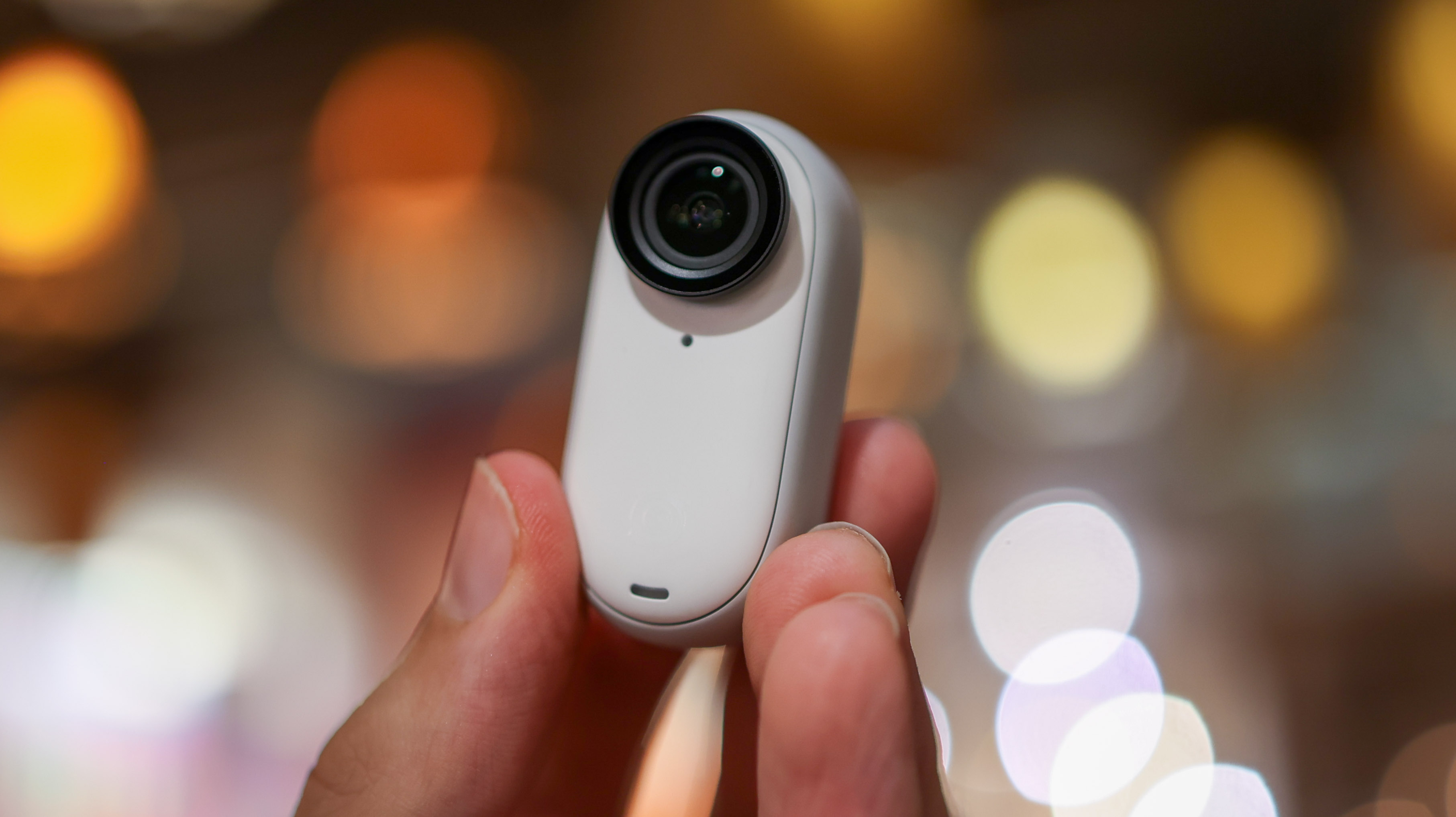 A photo of the Insta360 Go 3 action camera out of its case, in hand
