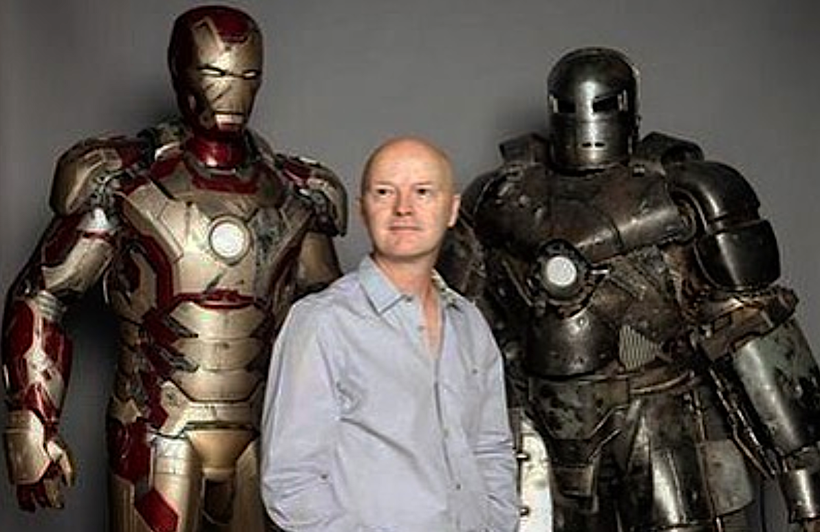 a man standing between two armored robot suits