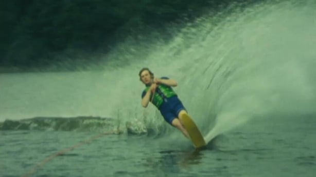 A man water-skiing on a lake