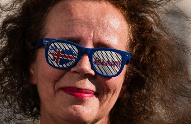 A supporter of the 'No' campaign wears sunglasses with the Icelandic colours during a rally against reopening Iceland's European Union accession negotiations in Reykjavik