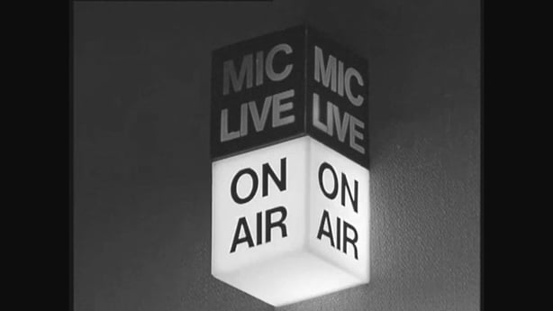 black and white image of an old mic live on air sign