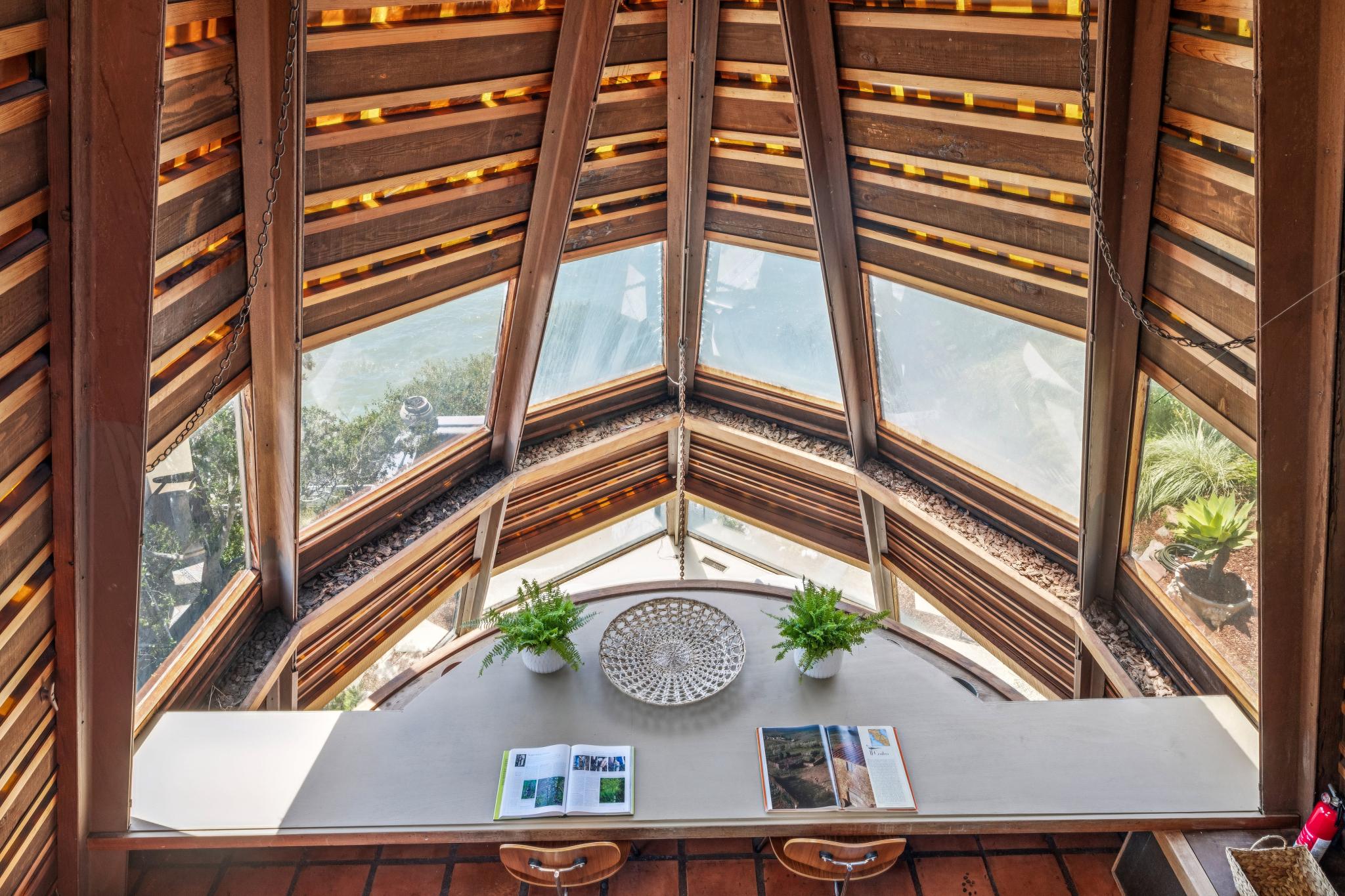 The first mezzanine level includes a long, built-in desk and chairs, perfect for either eating a meal or working from home