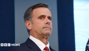 John Ratcliffe seen in a navy suit, with a red tie.