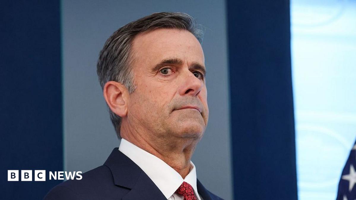 John Ratcliffe seen in a navy suit, with a red tie.