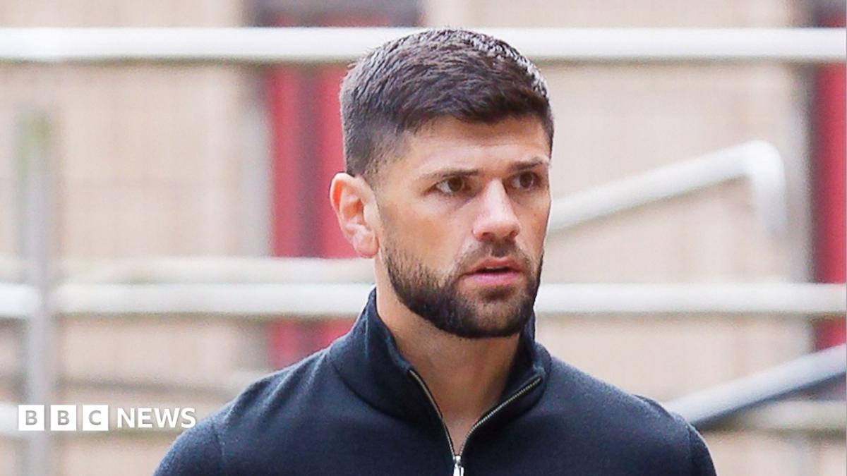 Joe Cordina, a man with brown hair and a brown beard. He's wearing a navy quarter-zip.