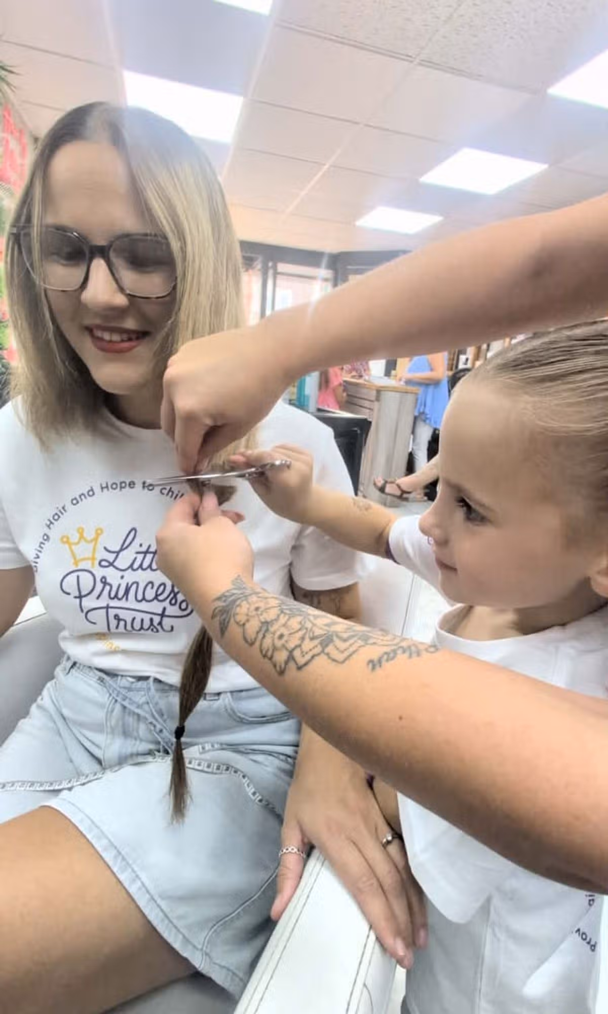 Nina helped cut her mum's hair off at the fundraising event on Friday