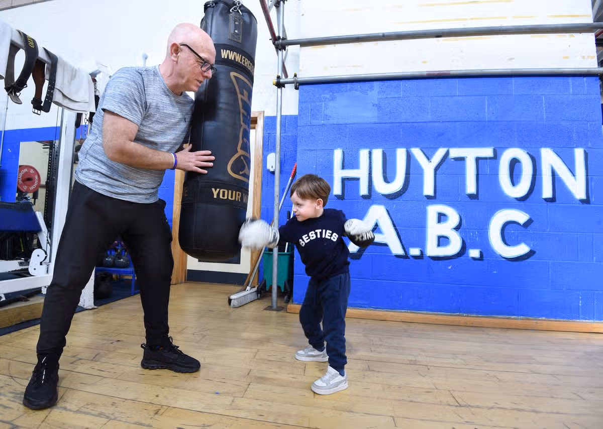 Boxing coach Andy Robinson with his son Teddy when he was three