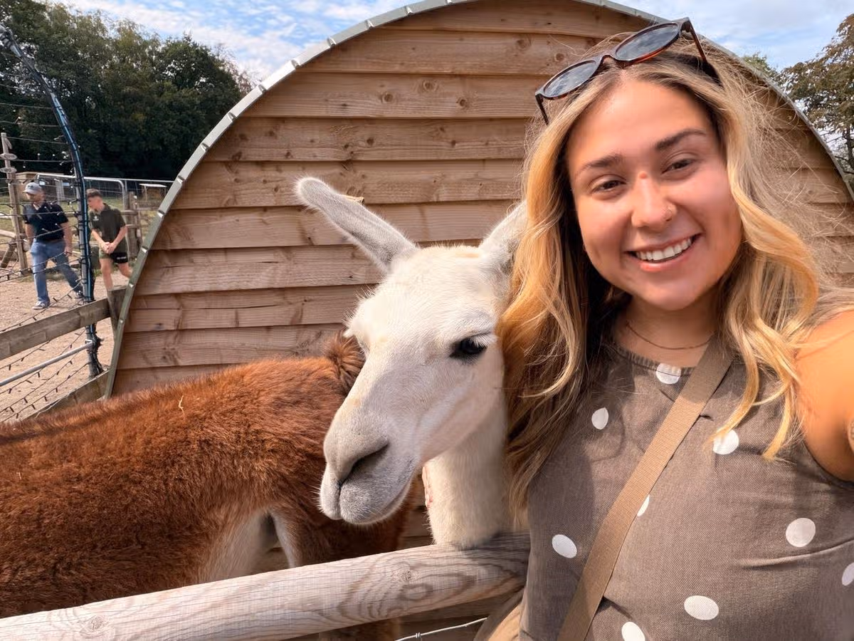 A woman hugging a llama