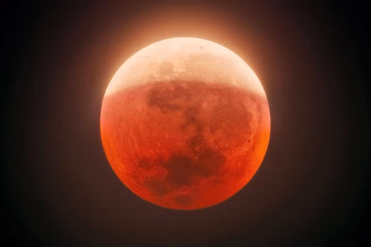 Partial lunar eclipse casting red glow on Moon