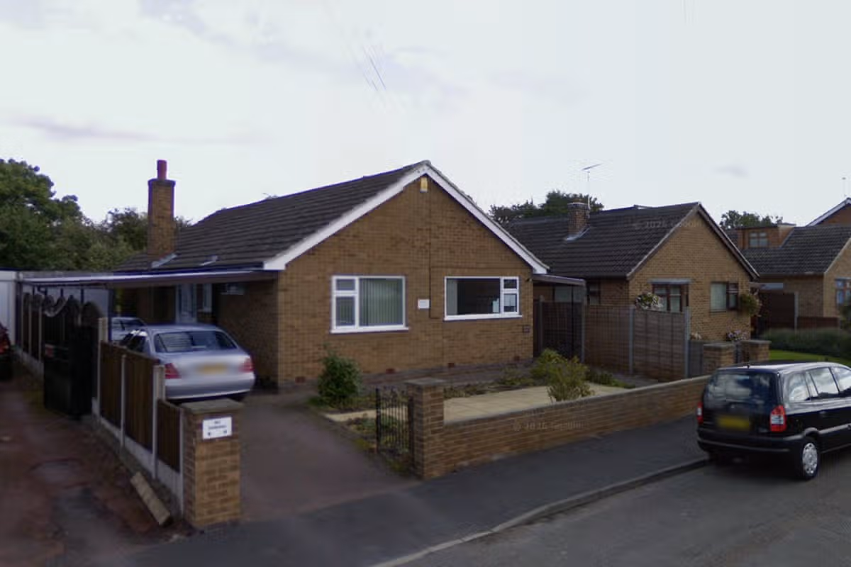 Residential bungalows on cul-de-sac type street, pictured on grey day, with cars parked outside and silver car under carport at side of bungalow closest to camera